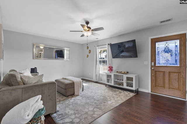 living room featuring ceiling fan and dark hardwood / wood-style floors