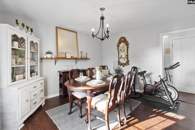 dining area featuring a notable chandelier and dark hardwood / wood-style flooring