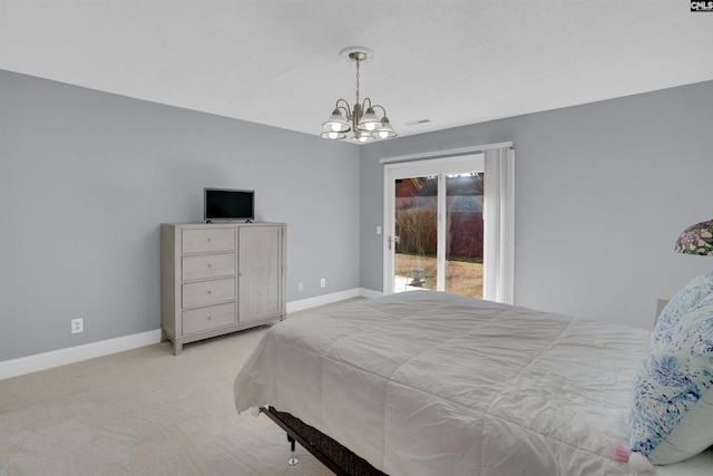 bedroom featuring a chandelier, access to outside, and light carpet