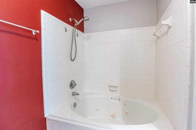 bathroom with tiled shower / bath combo and a textured ceiling