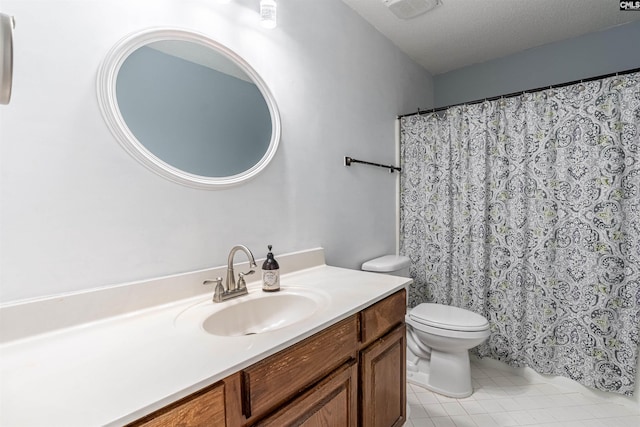 bathroom with vanity, tile patterned flooring, toilet, and a textured ceiling