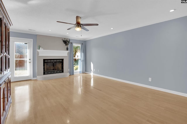 unfurnished living room featuring light wood-type flooring, crown molding, and ceiling fan