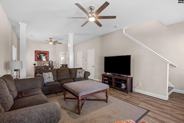 living room featuring ceiling fan, decorative columns, and hardwood / wood-style floors