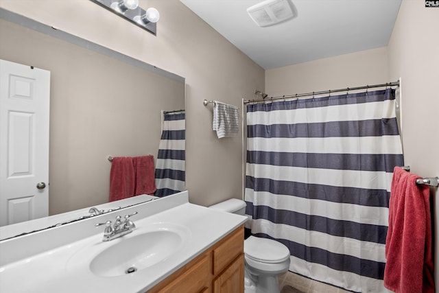 bathroom featuring vanity, tile patterned flooring, toilet, and walk in shower