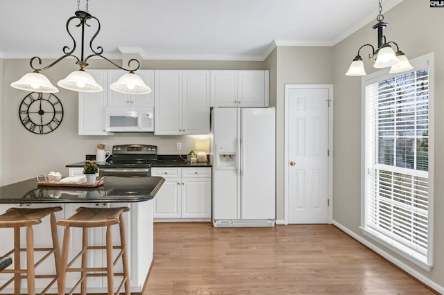 kitchen featuring white appliances, crown molding, pendant lighting, and white cabinetry