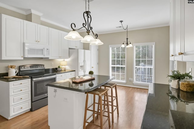 kitchen with light wood-type flooring, hanging light fixtures, white appliances, white cabinets, and crown molding