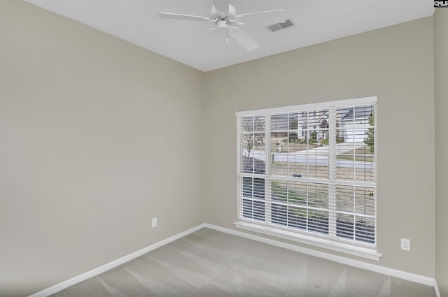 spare room featuring ceiling fan and carpet flooring