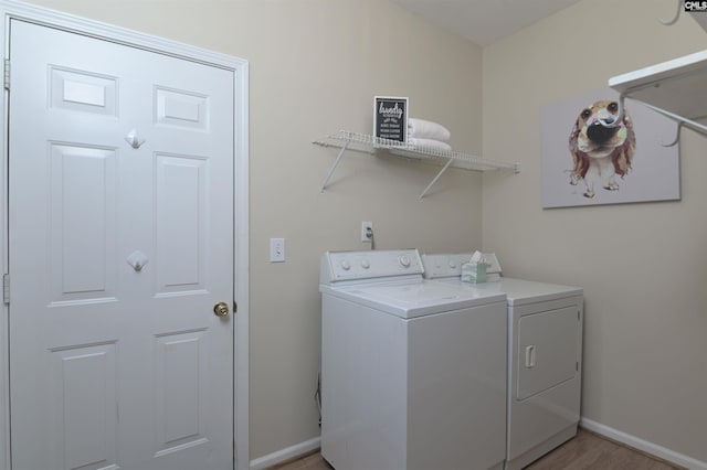 laundry area featuring hardwood / wood-style floors and washing machine and dryer