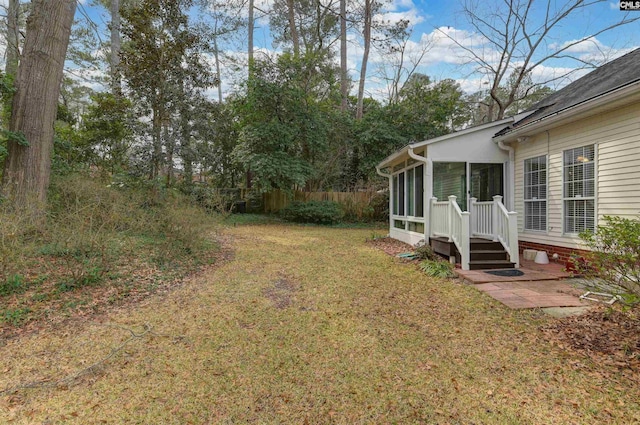 view of yard featuring a sunroom