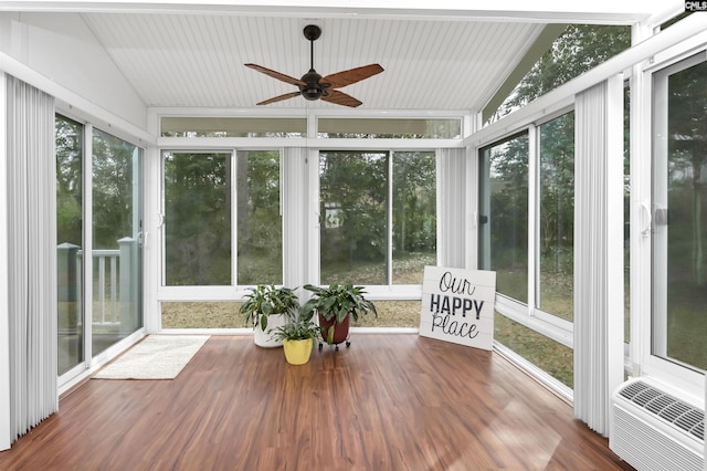 unfurnished sunroom featuring ceiling fan, vaulted ceiling, and a healthy amount of sunlight