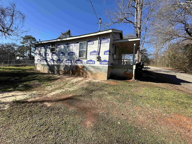 view of home's exterior with a lawn