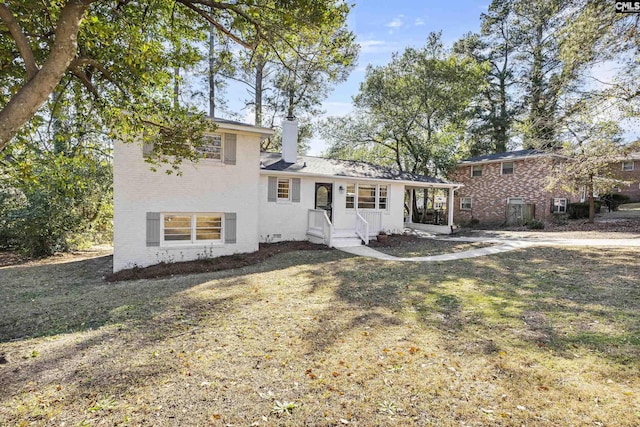 tri-level home with a front lawn