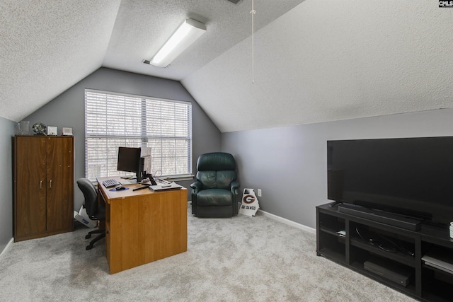 home office with light carpet, vaulted ceiling, and a textured ceiling