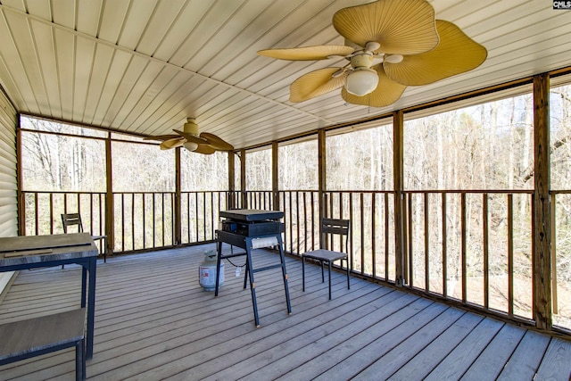 unfurnished sunroom with ceiling fan and wooden ceiling