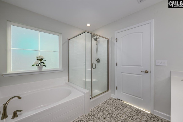 bathroom featuring tile patterned flooring and shower with separate bathtub