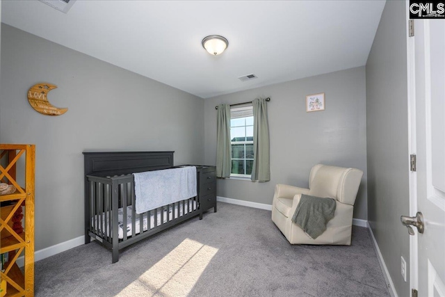 carpeted bedroom with a crib