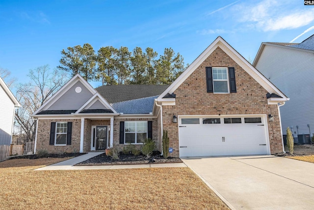 view of front of property featuring central air condition unit, a front lawn, and a garage