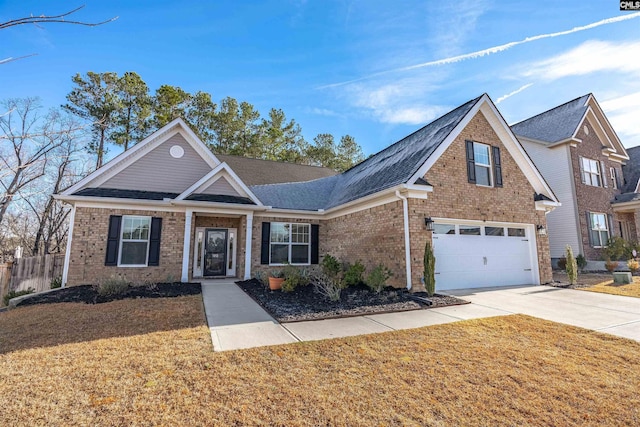 view of front of home featuring a front lawn and a garage