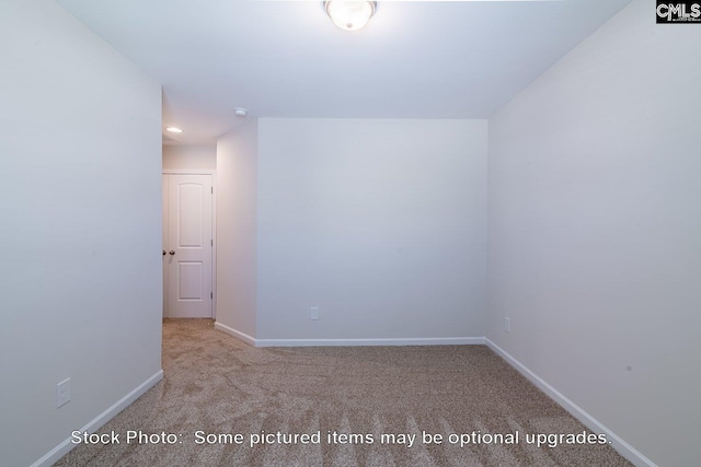 unfurnished room featuring light colored carpet