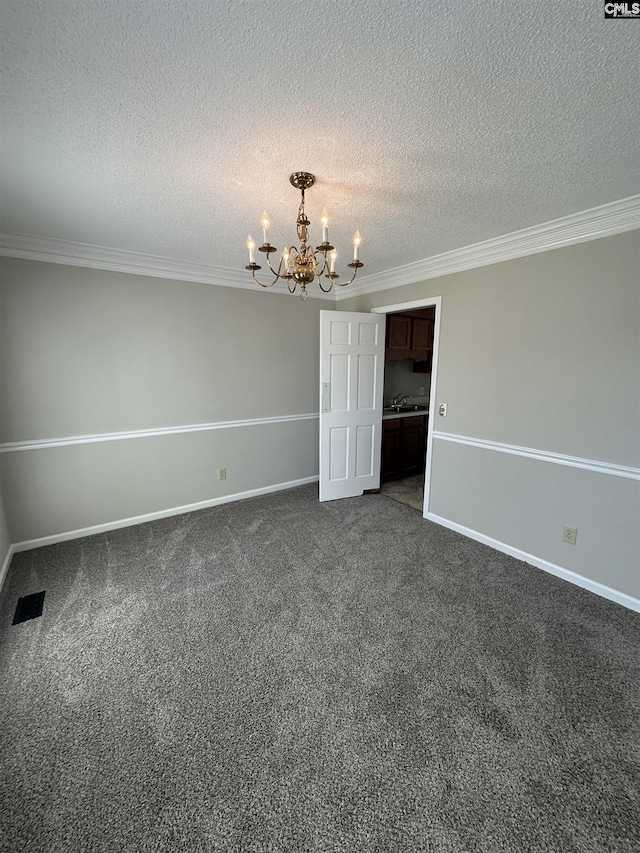 empty room with ornamental molding, dark colored carpet, an inviting chandelier, and a textured ceiling