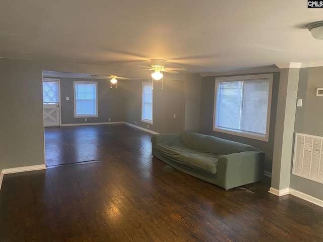 unfurnished living room with dark hardwood / wood-style flooring and ceiling fan