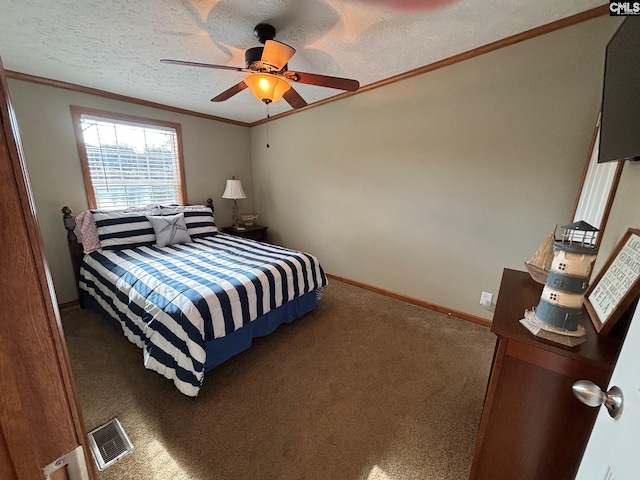 carpeted bedroom with a textured ceiling, ornamental molding, and ceiling fan