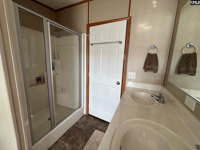 bathroom with a shower with shower door and vanity