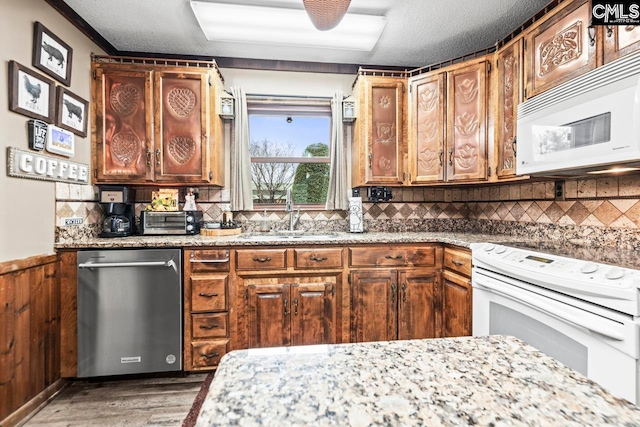 kitchen with white appliances, dark wood-type flooring, a textured ceiling, decorative backsplash, and sink