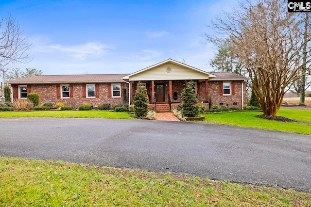 ranch-style home with a front yard and a porch