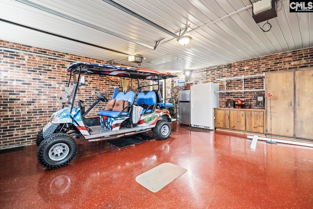 garage with a garage door opener, stainless steel refrigerator, and white fridge