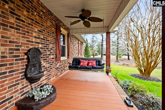 deck with ceiling fan and a porch