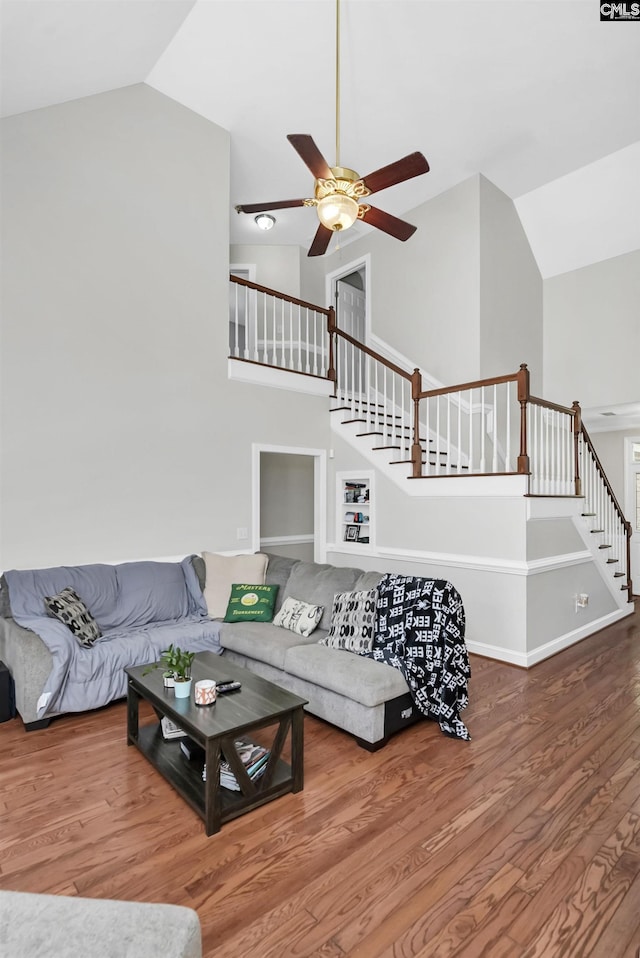 living room featuring high vaulted ceiling, hardwood / wood-style flooring, and ceiling fan