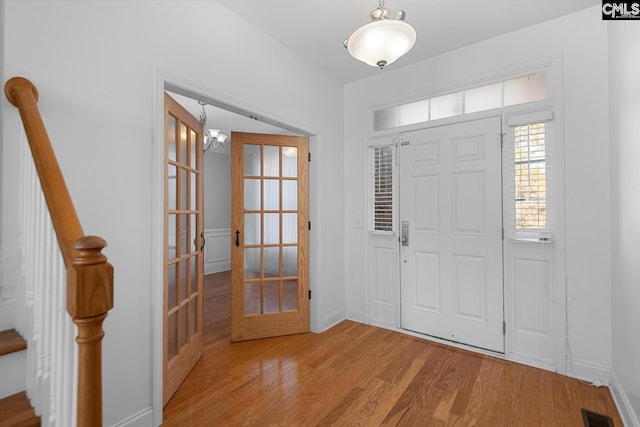 entrance foyer featuring light hardwood / wood-style floors and french doors