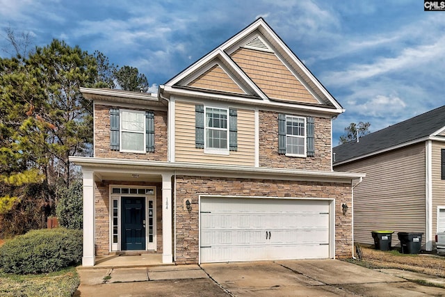 view of front facade featuring stone siding, an attached garage, and driveway