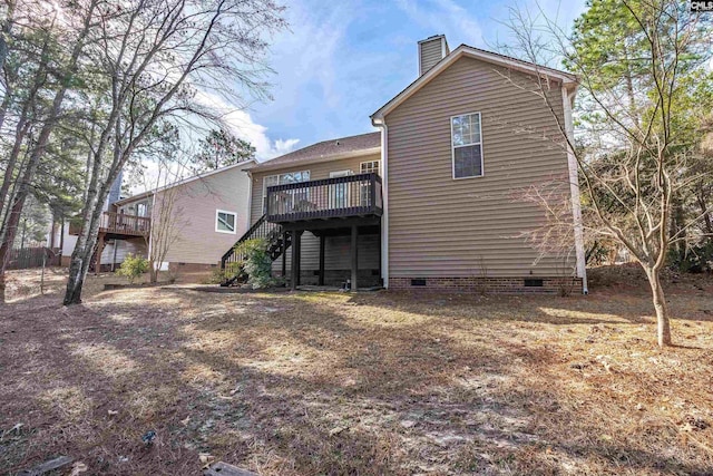 rear view of house with a wooden deck