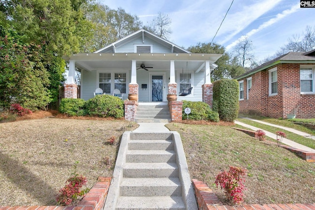 bungalow-style home with ceiling fan, a porch, and a front yard