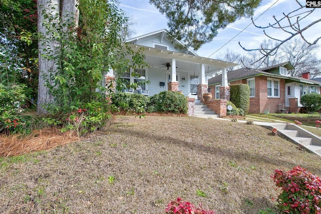 view of front of property with covered porch and a front yard