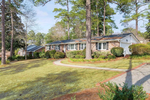 ranch-style home featuring a garage and a front lawn