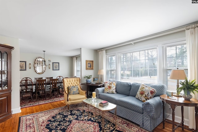 living room with an inviting chandelier, hardwood / wood-style flooring, and plenty of natural light