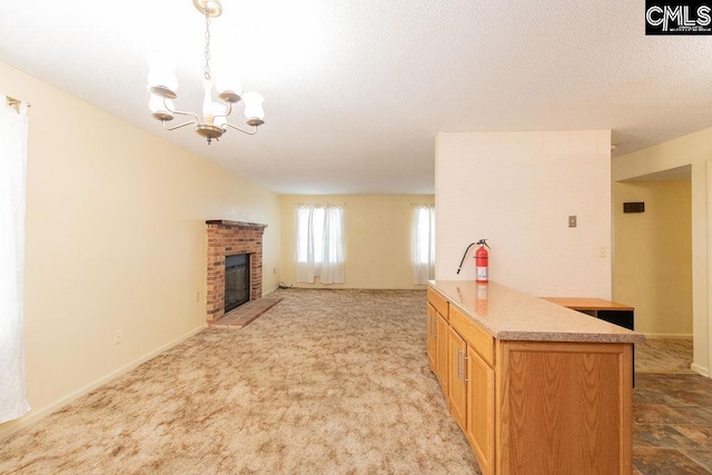 living room featuring a textured ceiling, a fireplace, a notable chandelier, and light colored carpet