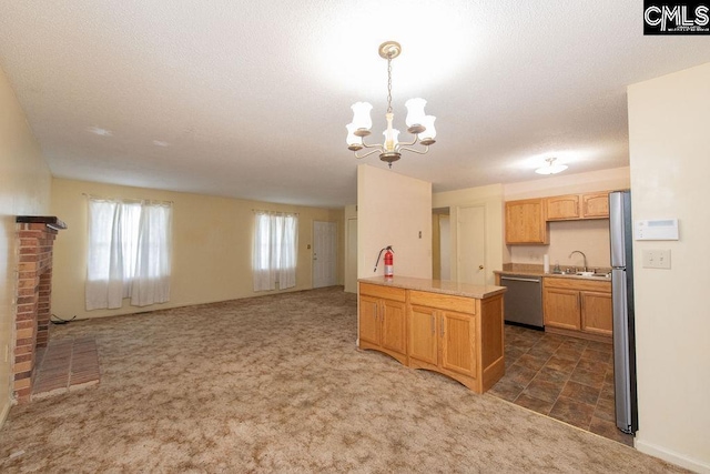 kitchen featuring light countertops, dark carpet, hanging light fixtures, appliances with stainless steel finishes, and open floor plan