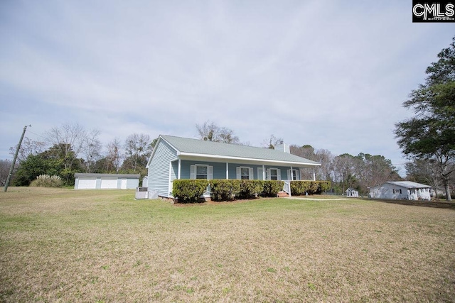 single story home featuring a front lawn, a chimney, a porch, and a detached garage