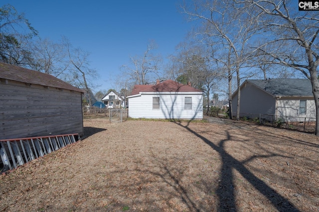 view of yard with fence and an outdoor structure