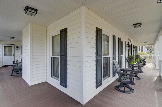 wooden terrace featuring covered porch