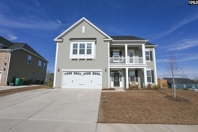 view of front facade with central AC unit, an attached garage, a balcony, covered porch, and driveway