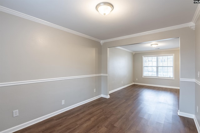 empty room featuring dark wood-style floors, baseboards, and crown molding