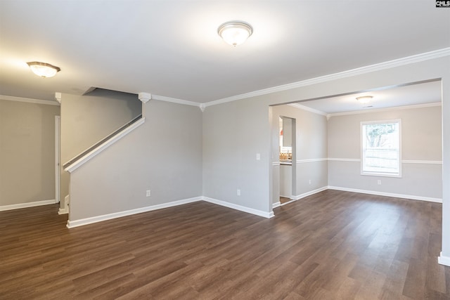 unfurnished room with ornamental molding, dark wood-type flooring, and baseboards