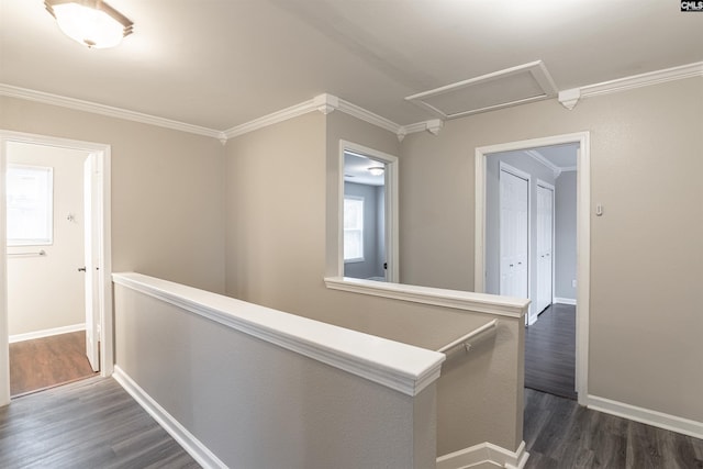 hall with attic access, baseboards, ornamental molding, dark wood-style flooring, and an upstairs landing