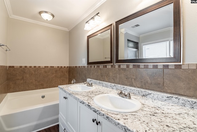 bathroom with a garden tub, visible vents, a sink, and ornamental molding