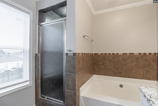 full bath featuring ornamental molding, a garden tub, vanity, and a shower stall